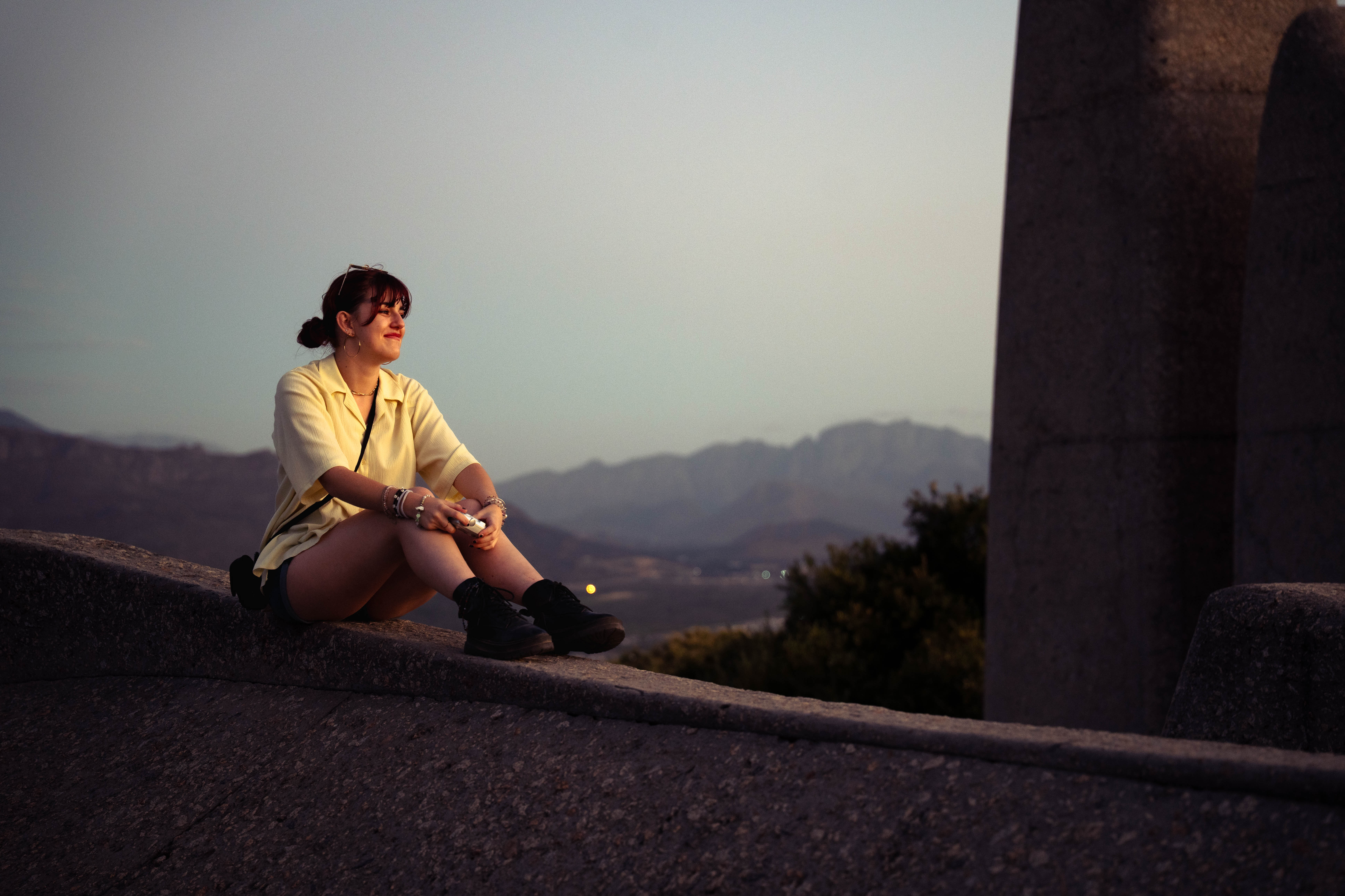 Lifestyle photography — woman walking into forest on dirt path